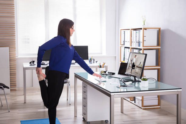 Young Businesswoman Looking At Invoice On Computer Doing Yoga